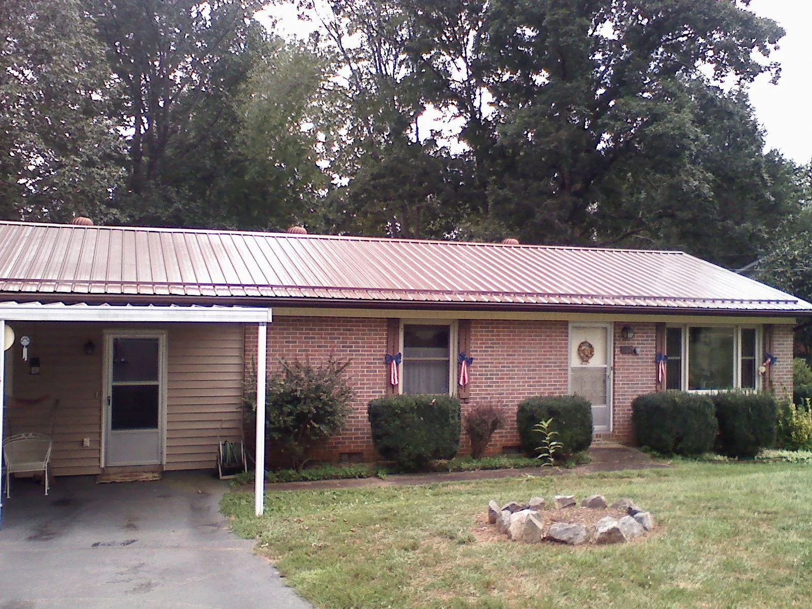 Bronze metal roof and carport on a brick ranch home — Roof Repair work by our crew in Shohola